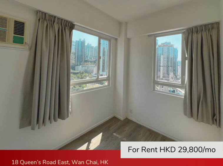 Spacious master bedroom with large windows and city views