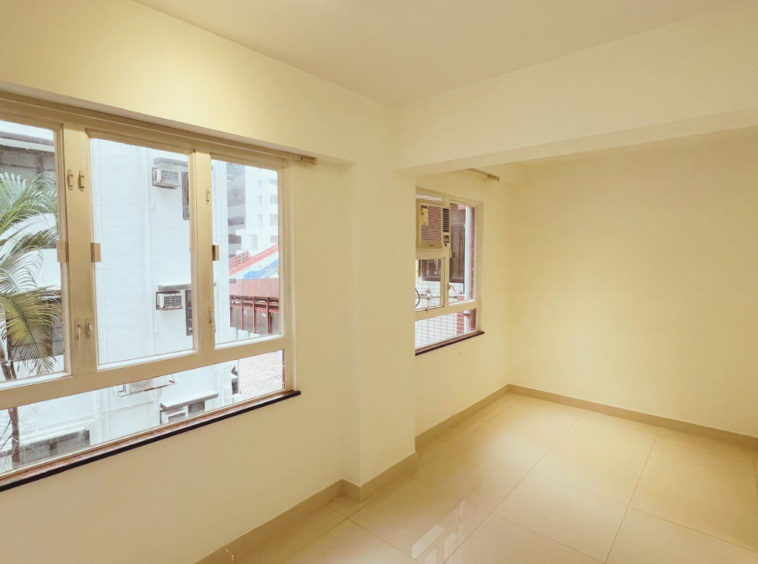 Wan Chai bedroom — one‑bed room with two air‑conditioners